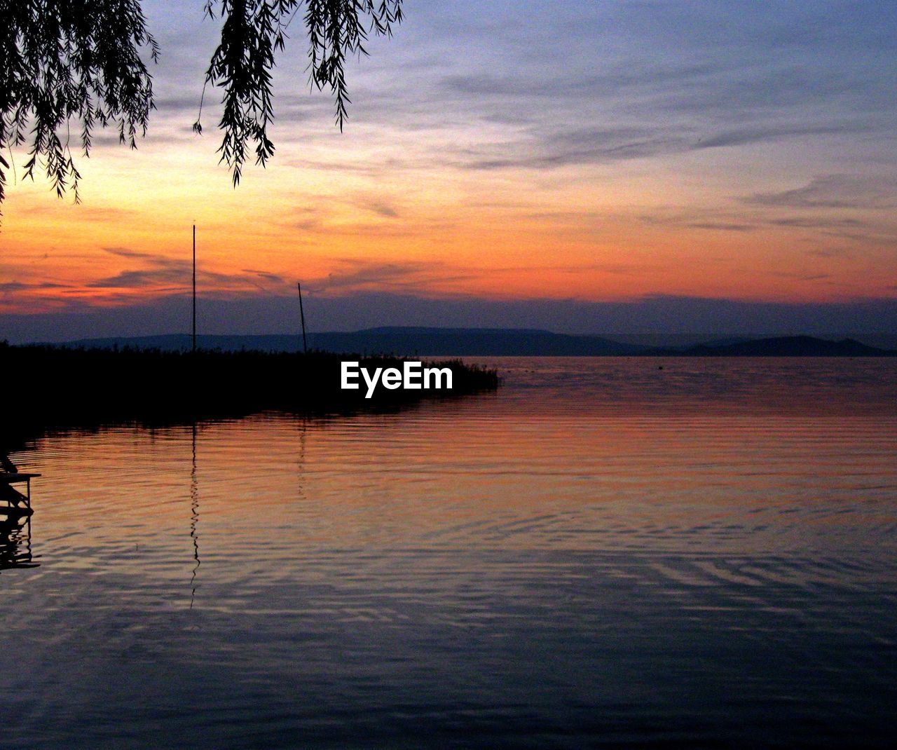 Scenic view of calm sea at sunset