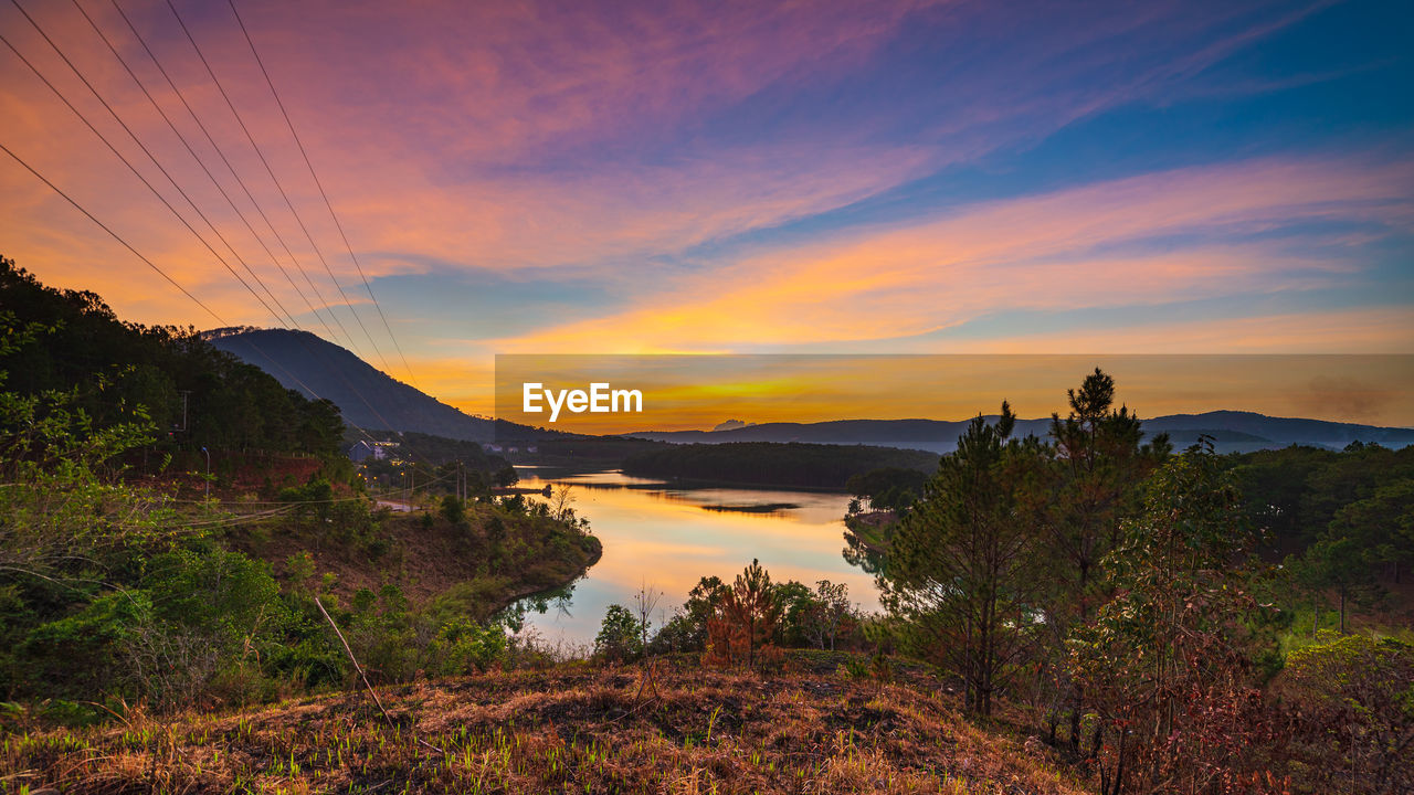 SCENIC VIEW OF MOUNTAIN AGAINST SKY DURING SUNSET