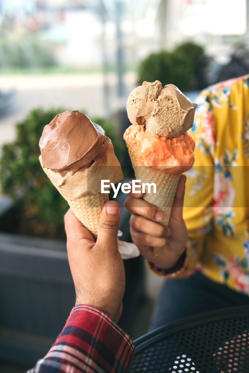 People holding ice cream cone