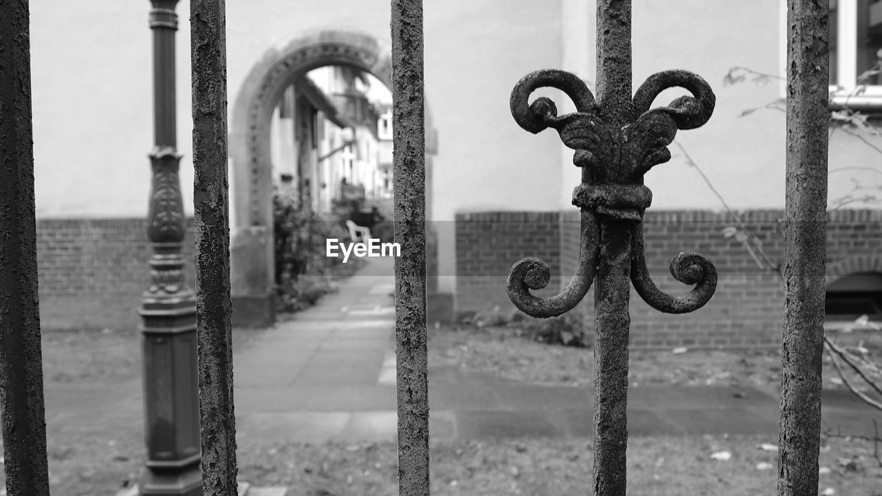 Close-up of metallic fence against building