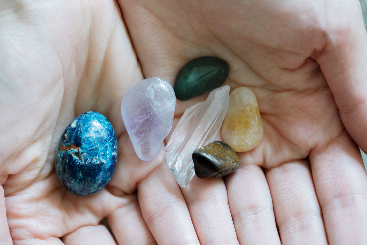 Hands holding colorful crystals