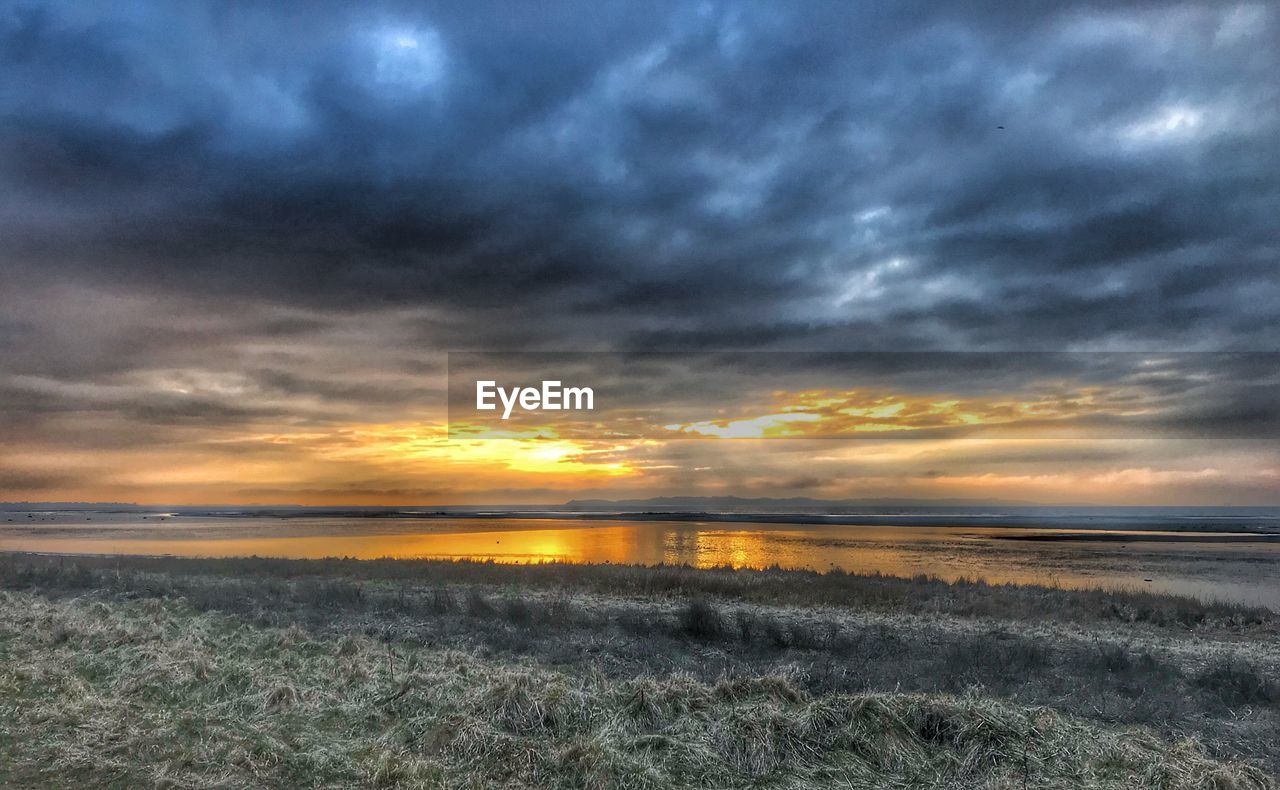 SCENIC VIEW OF SEA AGAINST STORM CLOUDS