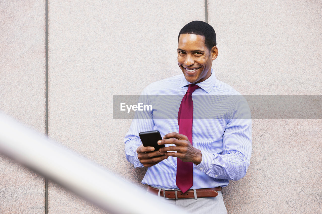 portrait of young man using mobile phone