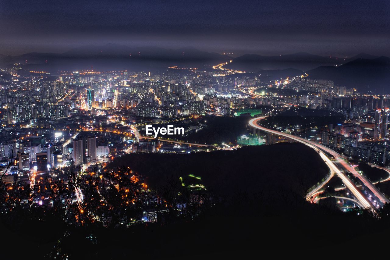 High angle view of illuminated city buildings at night