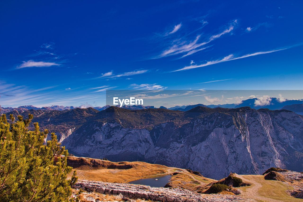 Scenic view of mountains against blue sky