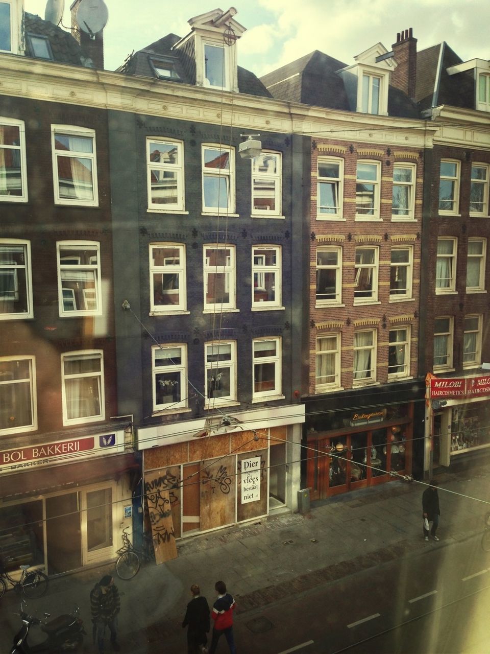 PEOPLE WALKING ON BUILDING TERRACE IN CITY