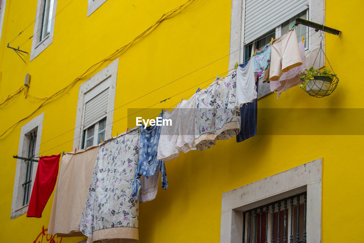 Exterior of yellow house with drying laundry