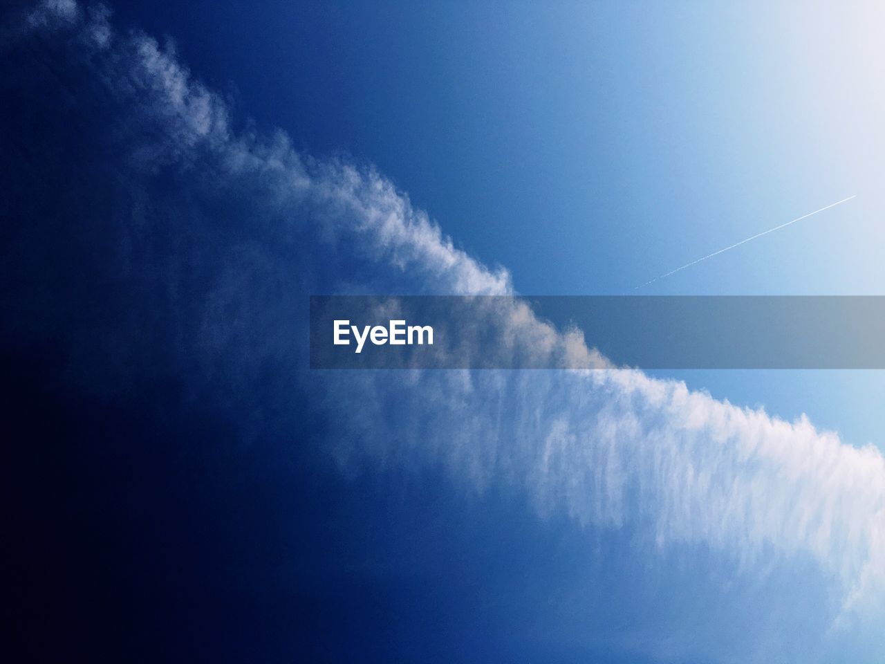 LOW ANGLE VIEW OF VAPOR TRAILS IN SKY