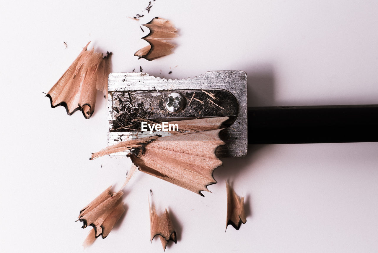 CLOSE-UP OF BROKEN PENCILS ON TABLE