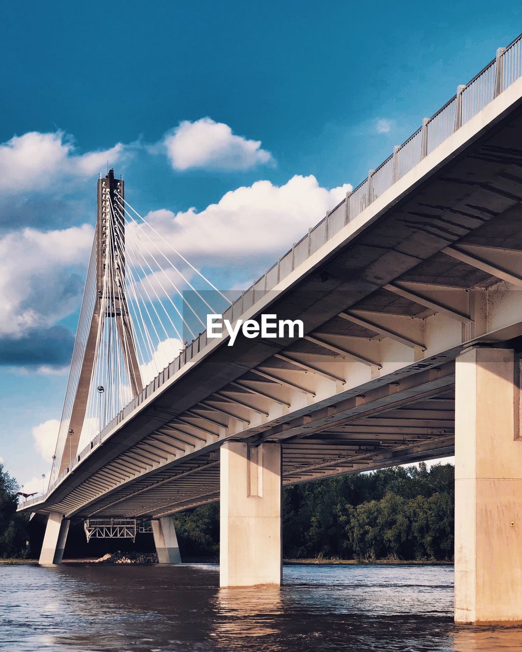 Low angle view of bridge over river against sky