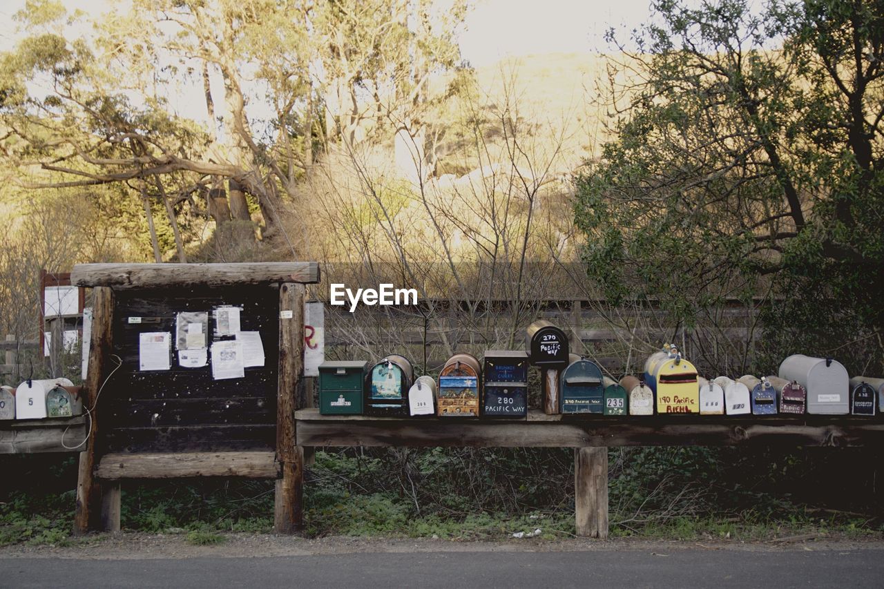 Mailboxes in row against plants