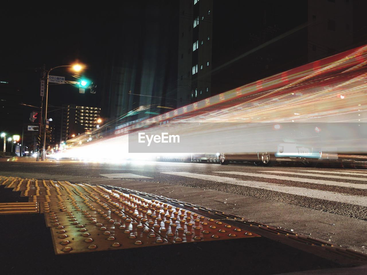 Light trails on street along buildings