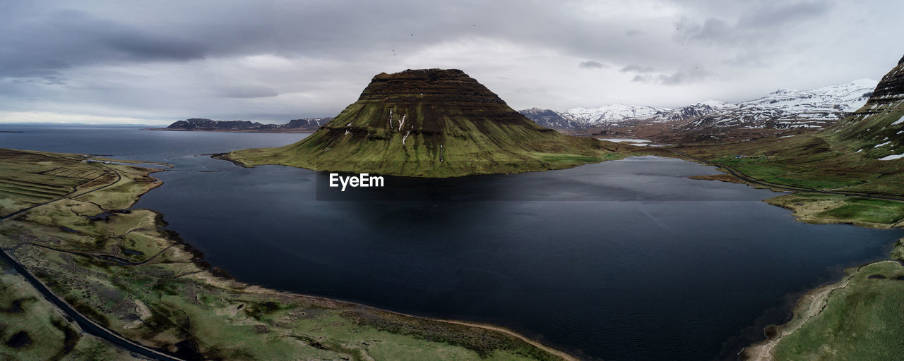 Scenic view of river and mountain against sky