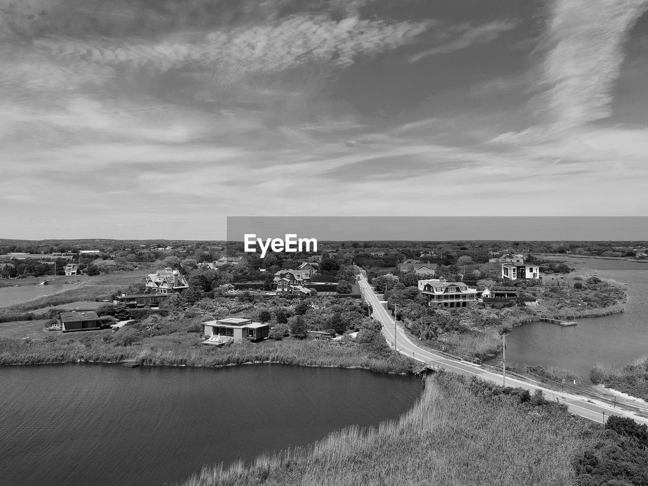 HIGH ANGLE VIEW OF RIVER AND BUILDINGS AGAINST SKY