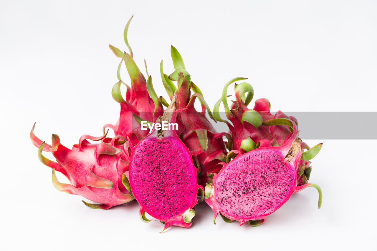 CLOSE-UP OF PINK FRUITS AND WHITE FLOWERS