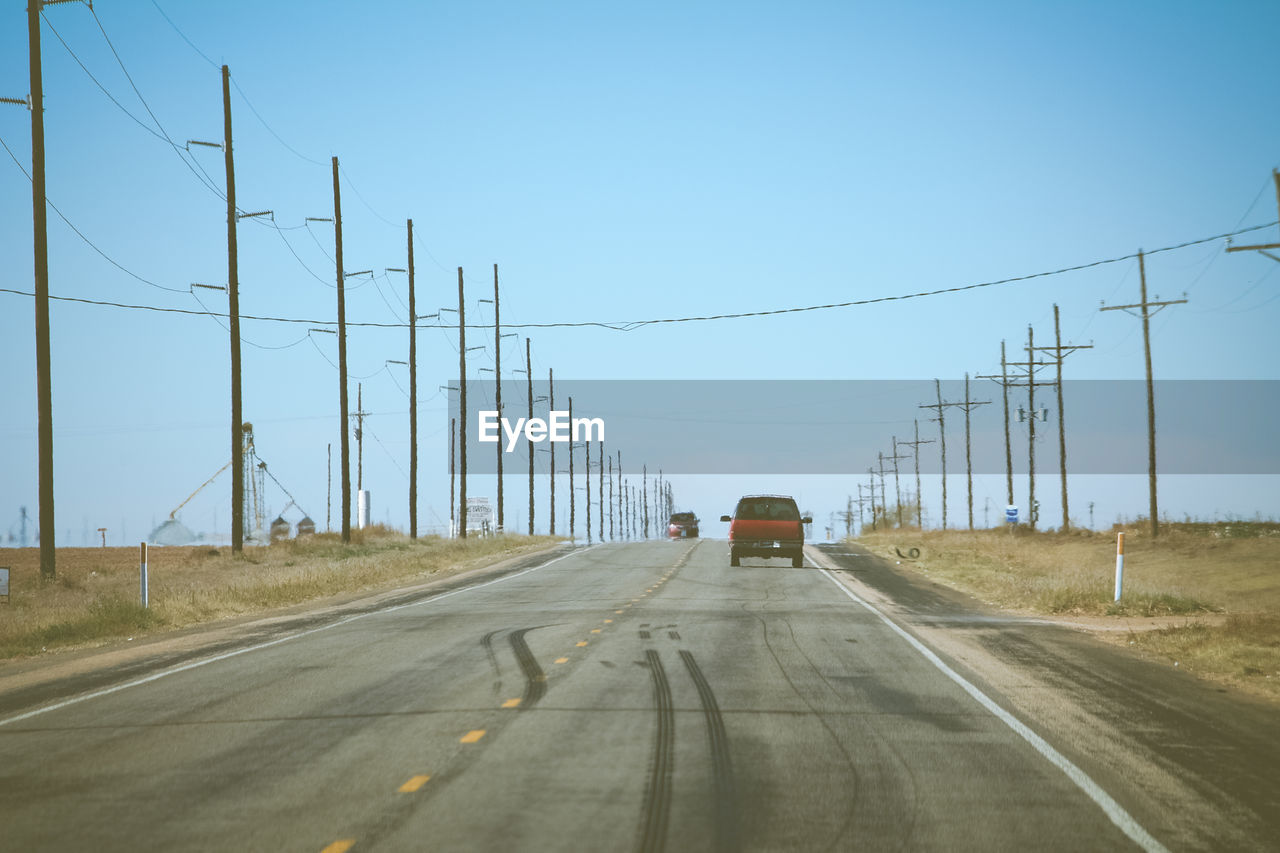 Cars on road against clear sky