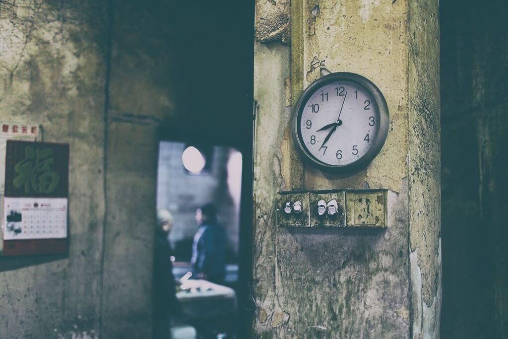 CLOSE-UP OF CLOCK ON WALL