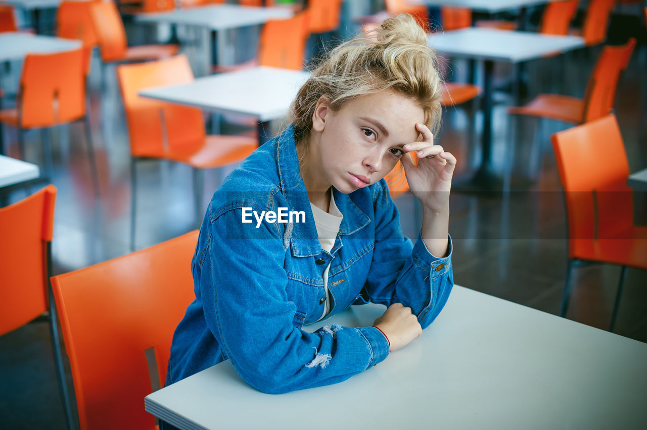 Portrait of young woman sitting at cafe