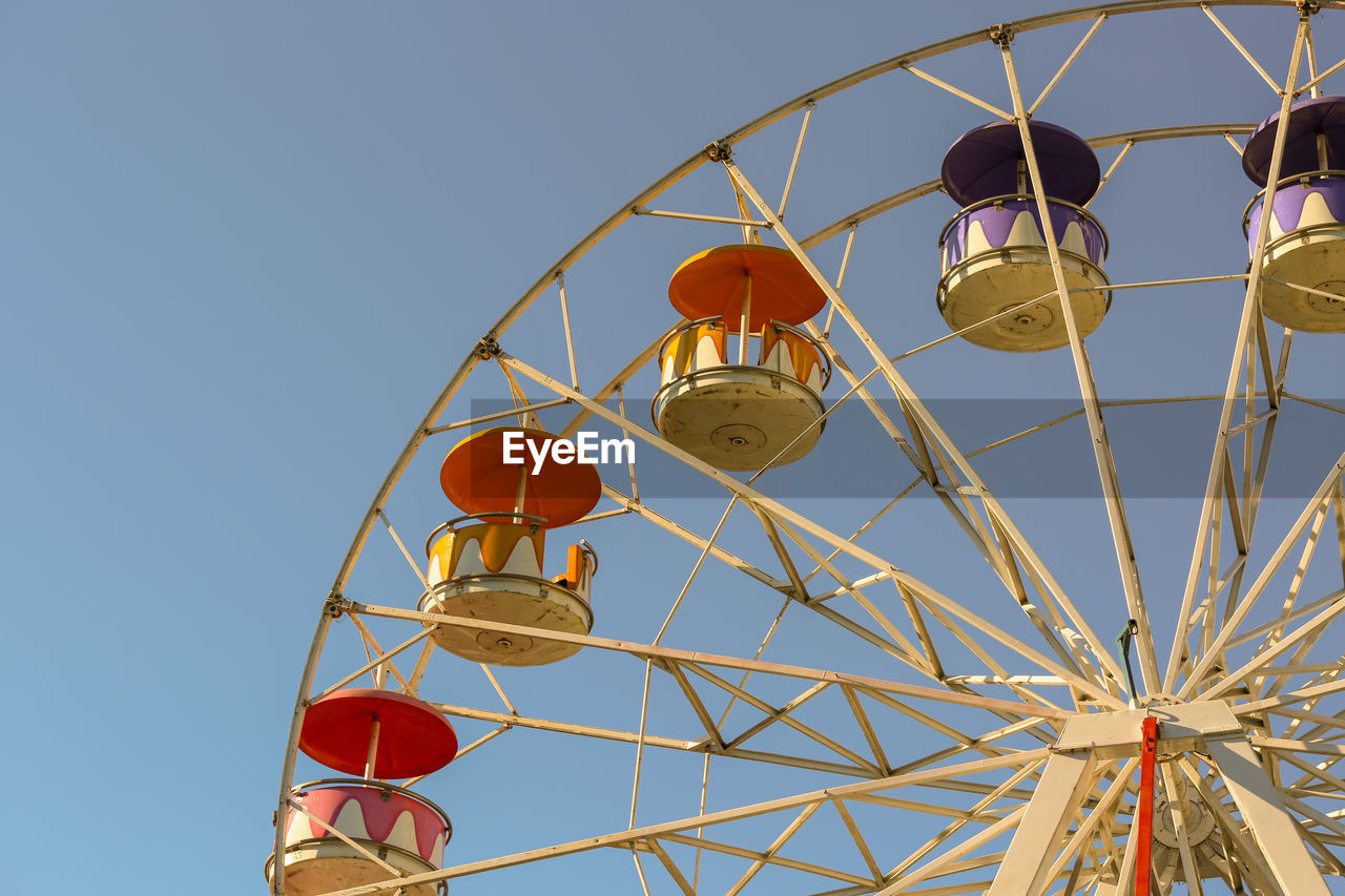 Low angle view of ferris wheel against sky