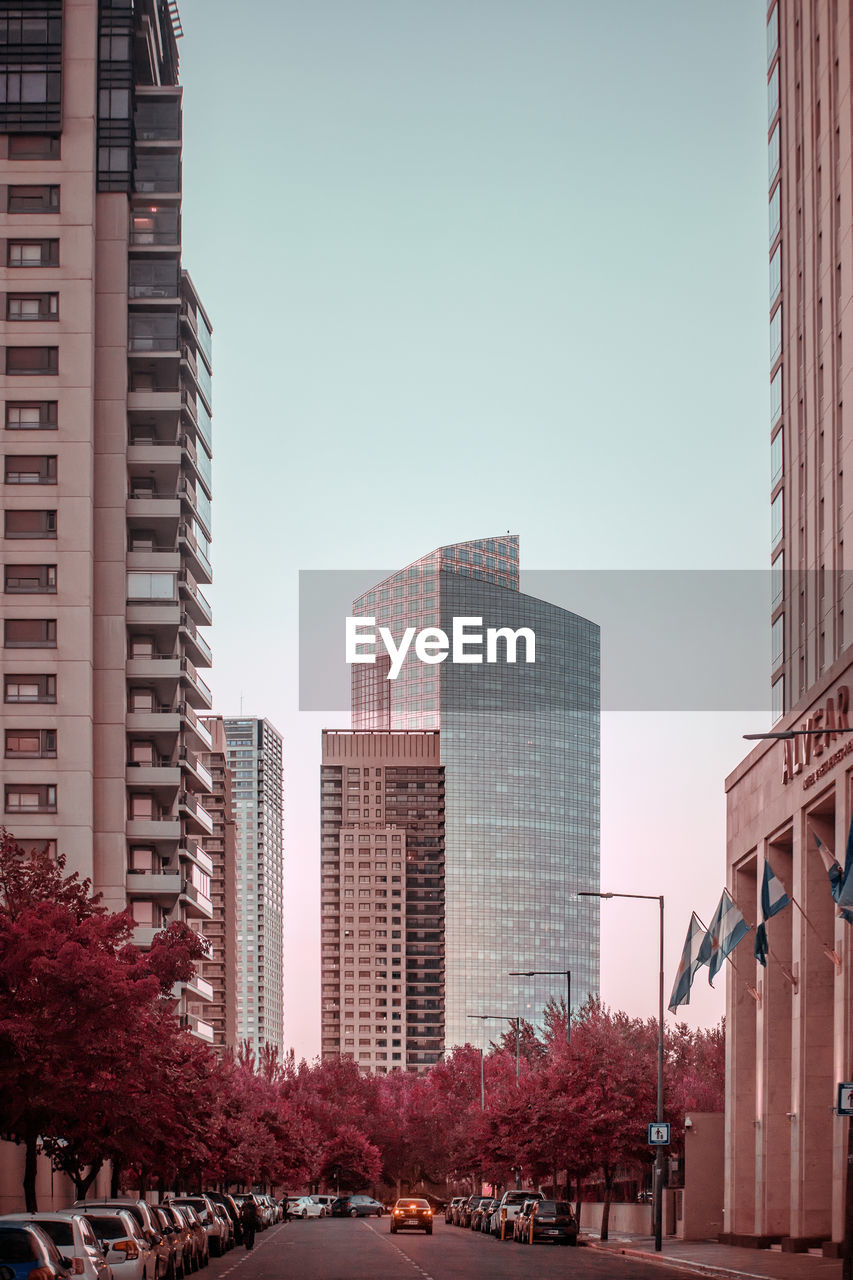 City buildings against clear sky during sunset