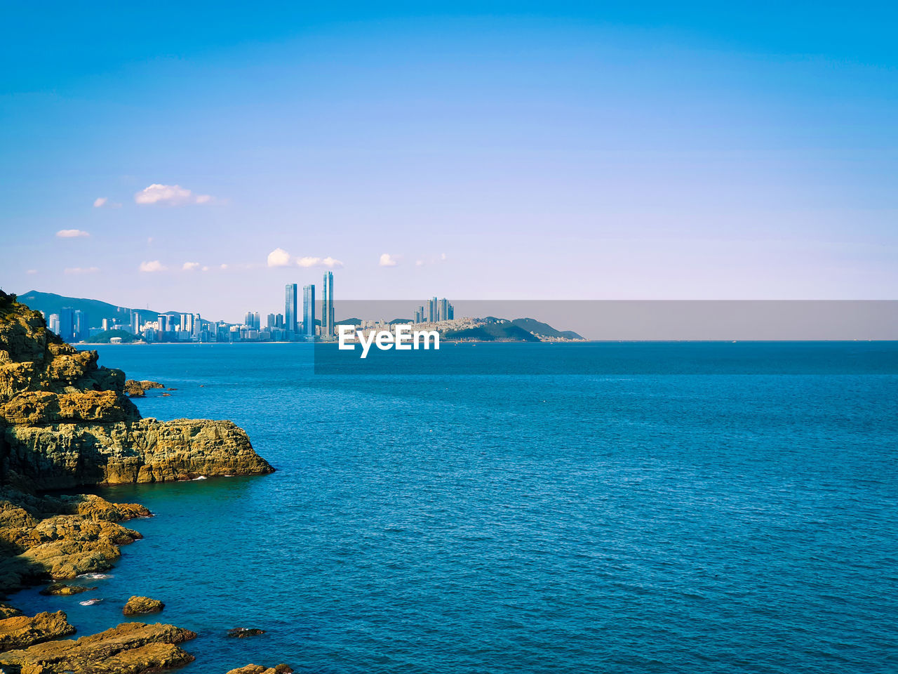 Scenic view of sea against blue sky