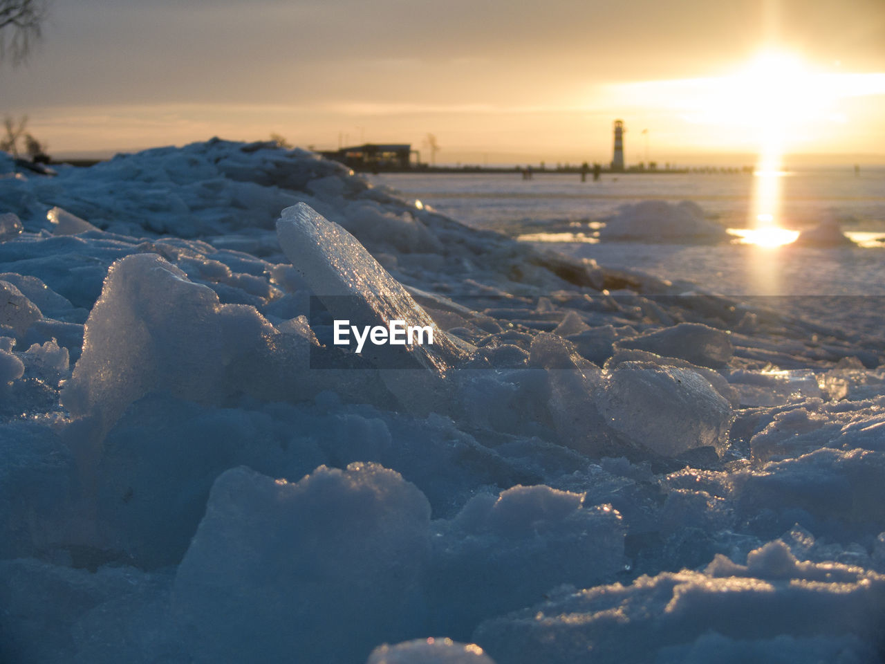 Scenic view of snow covered landscape at sunset