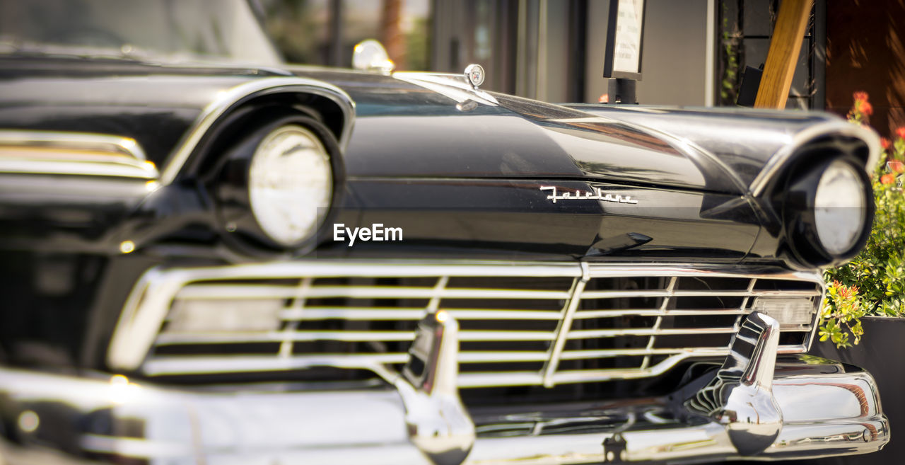 CLOSE-UP OF VINTAGE CAR ON BUS