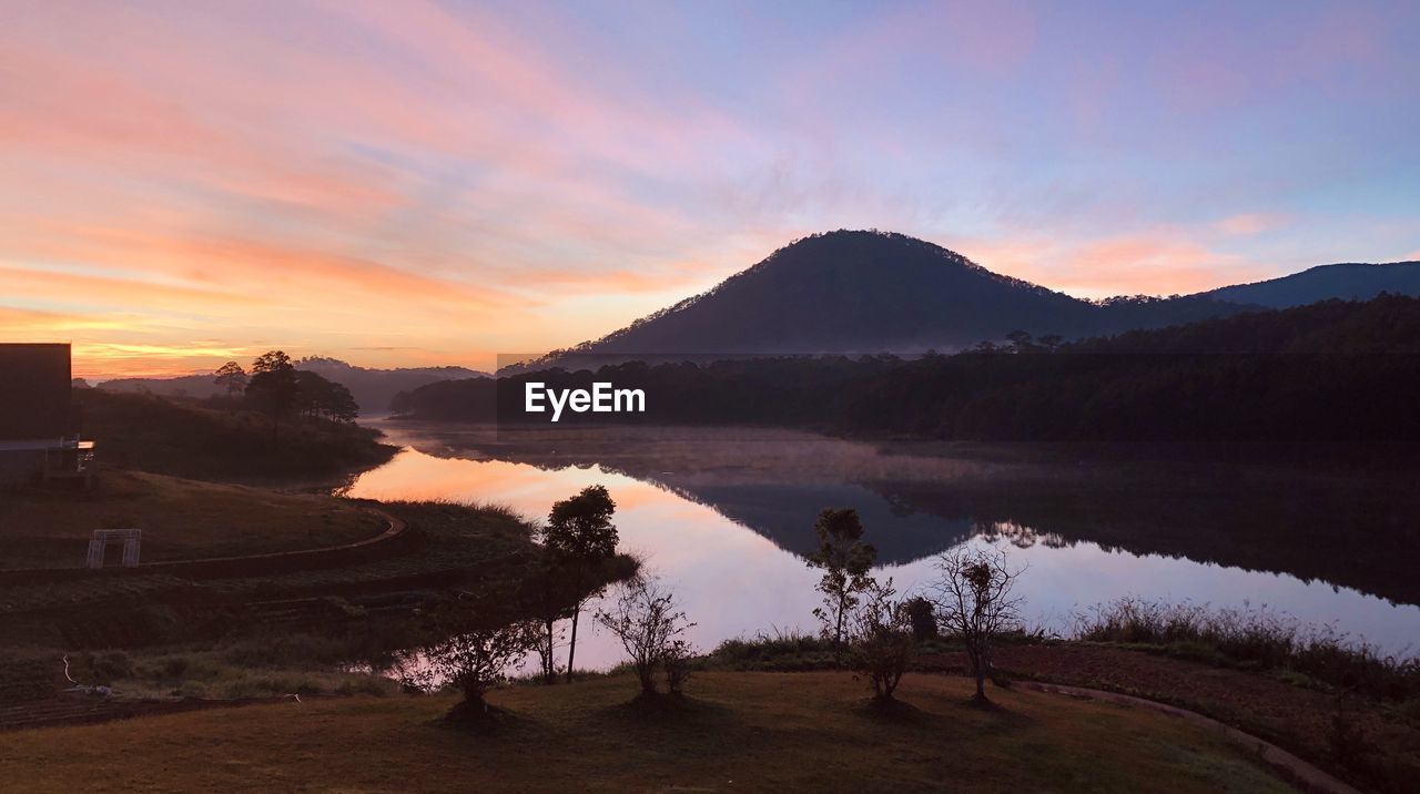 Scenic view of lake against sky during sunset