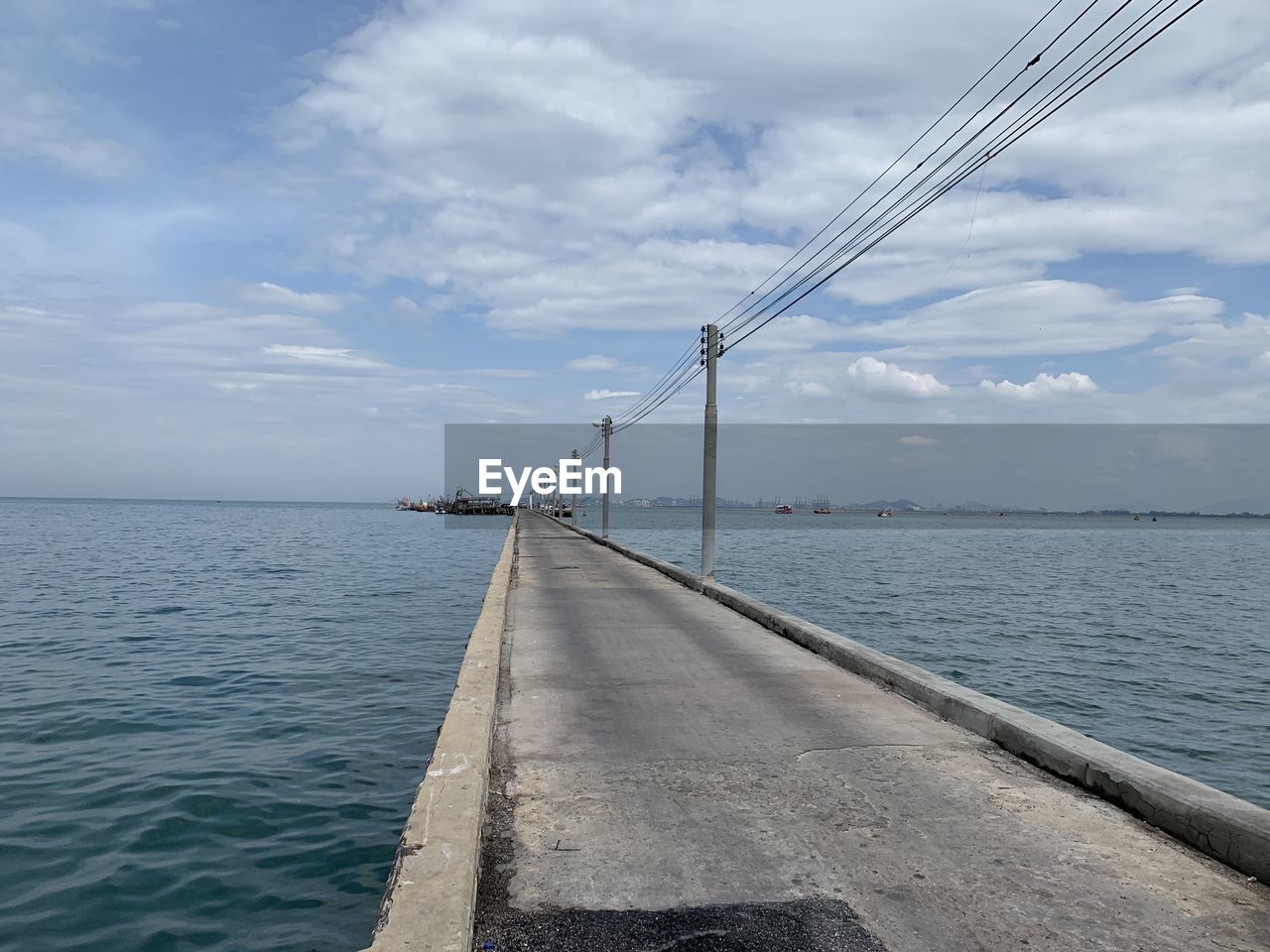 BRIDGE OVER CALM SEA AGAINST SKY