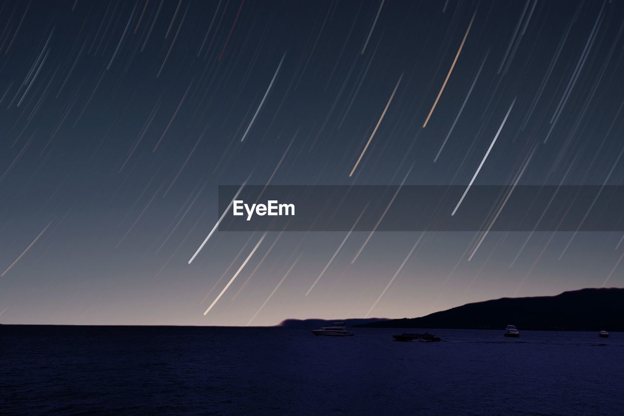 Lightning over sea against sky at night