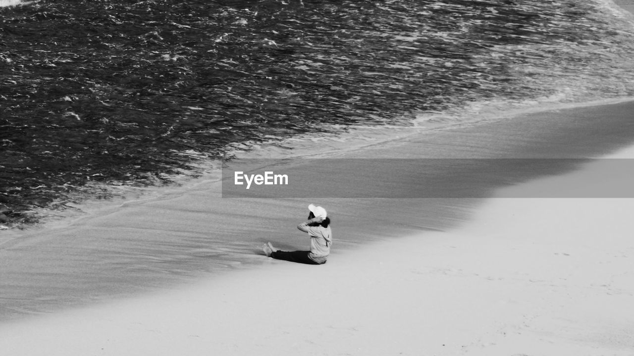 High angle view of people walking on snow covered landscape