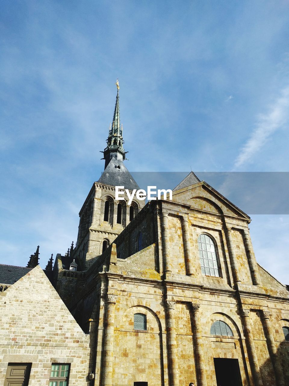 Low angle view of mont saint-michel against sky