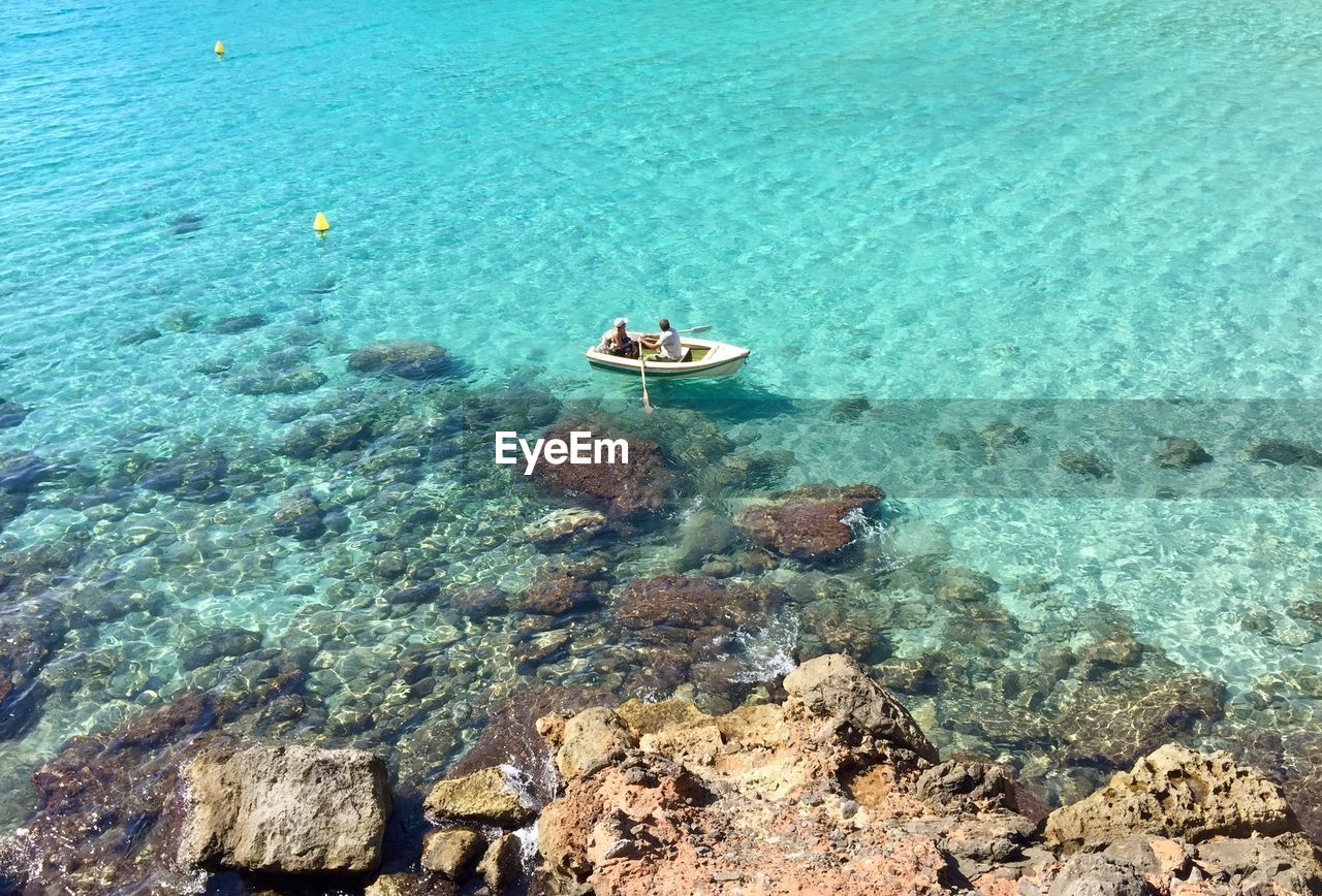 High angle view of two people kayaking in sea