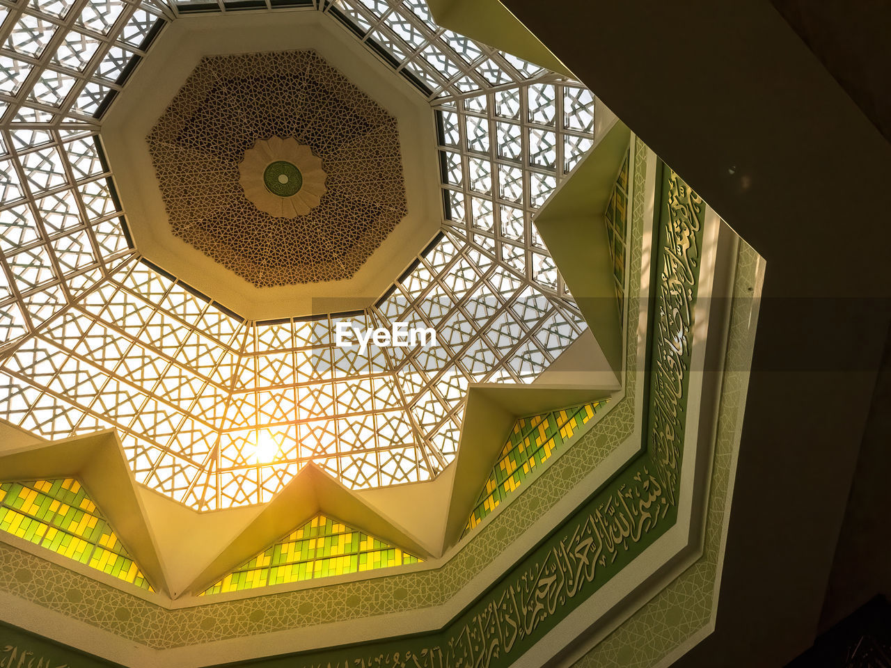 pattern, architecture, ceiling, indoors, lighting, yellow, built structure, no people, shape, directly below, ornate, geometric shape, lighting equipment, decoration, low angle view, building, illuminated, architectural feature, art, gold, hexagon, light