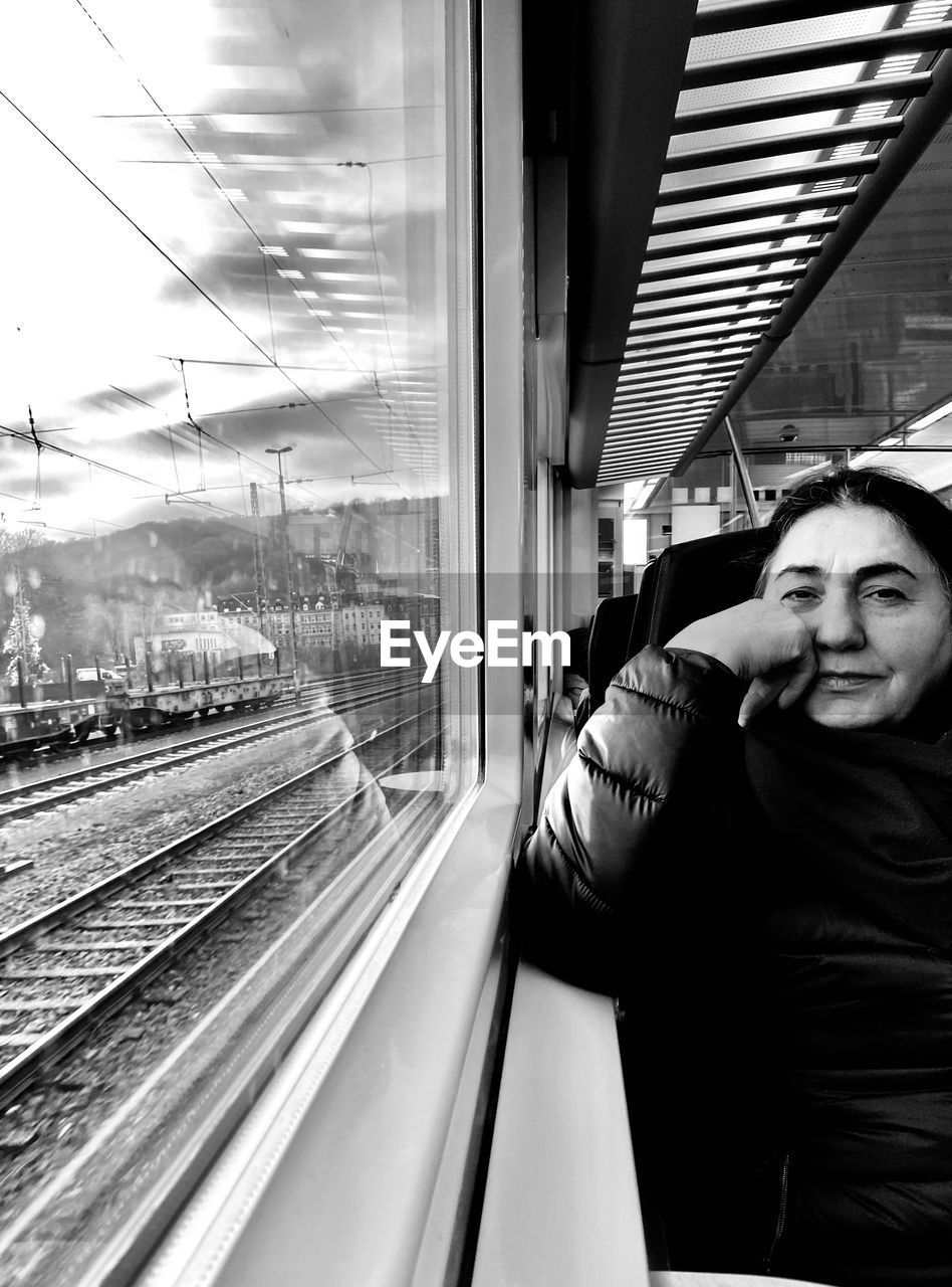 Portrait of woman looking through train window