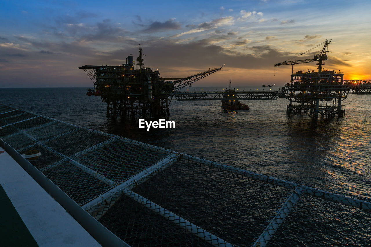 Sunset at oil field viewed from a helideck of a construction work barge at offshore oil fieldkuala