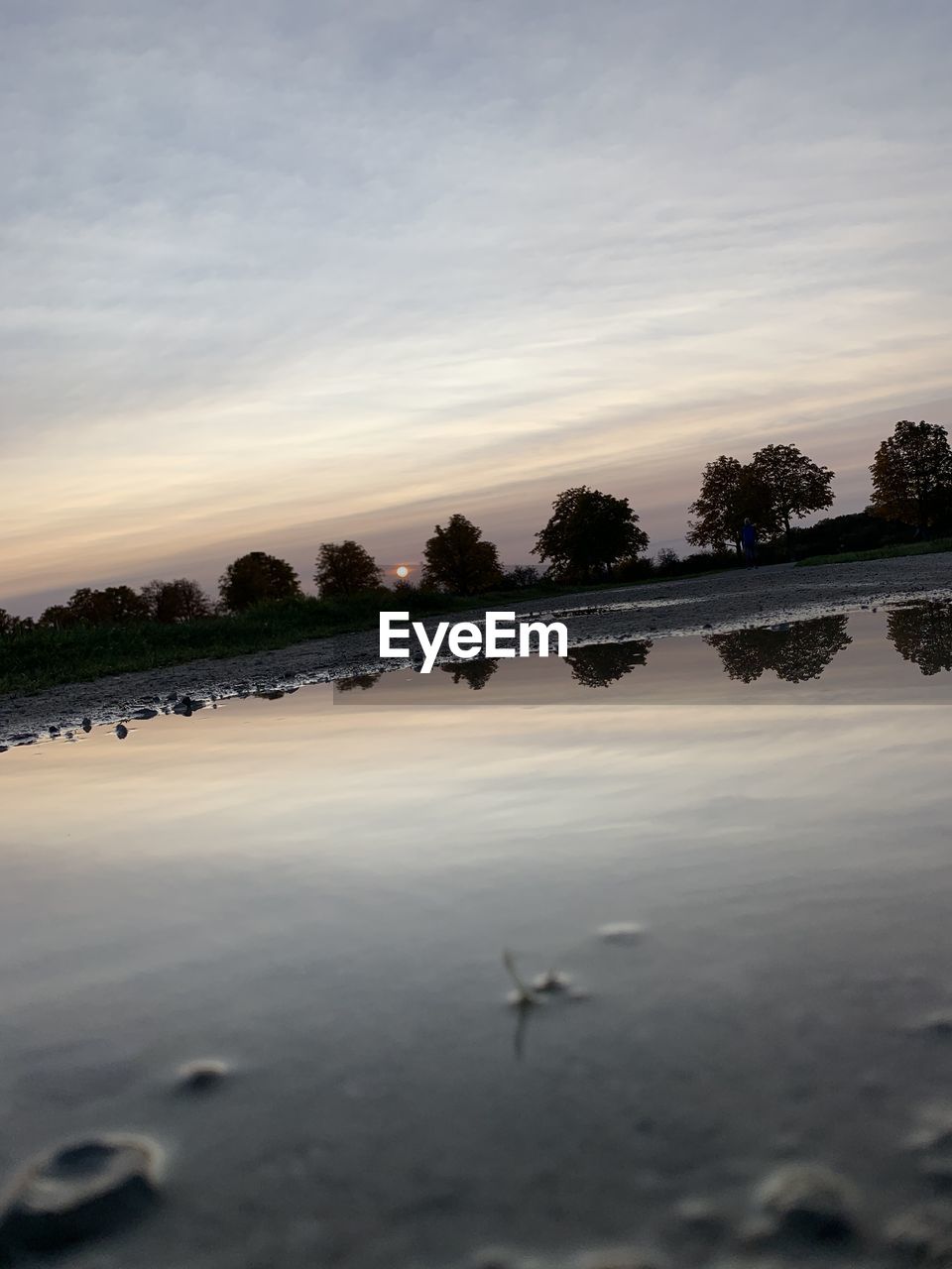 SCENIC VIEW OF LAKE AT SUNSET