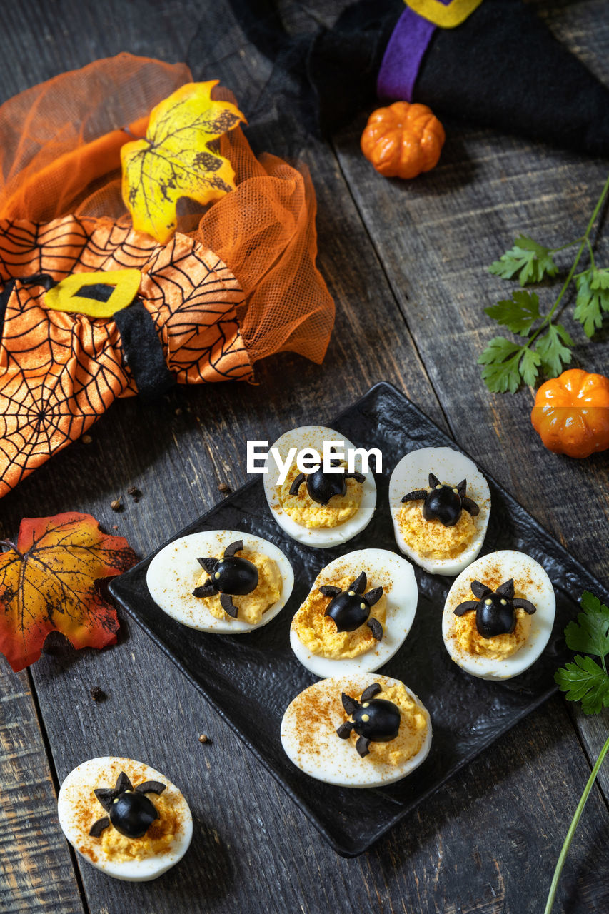 Halloween funny idea for party food. halloween creative set stuffed eggs with paprica and bat