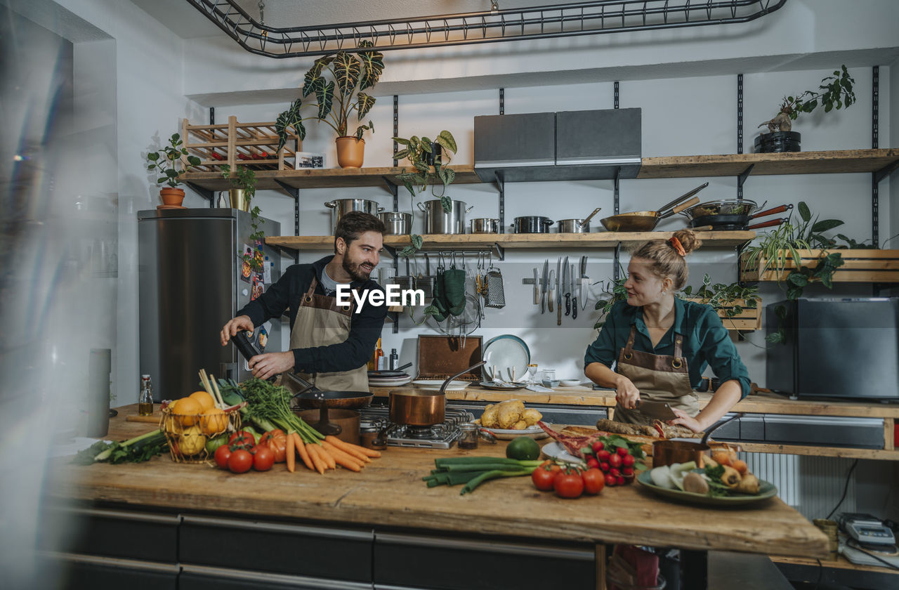 Chefs smiling while working in kitchen