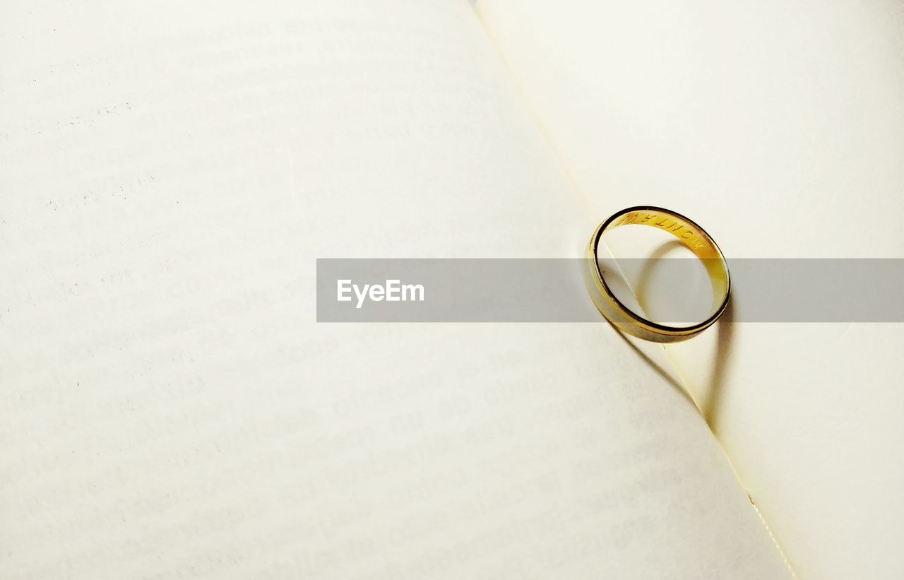 Close-up of wedding ring on open book