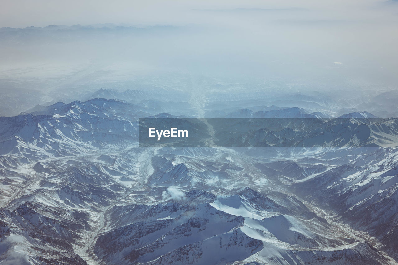 high angle view of snow covered mountains against sky