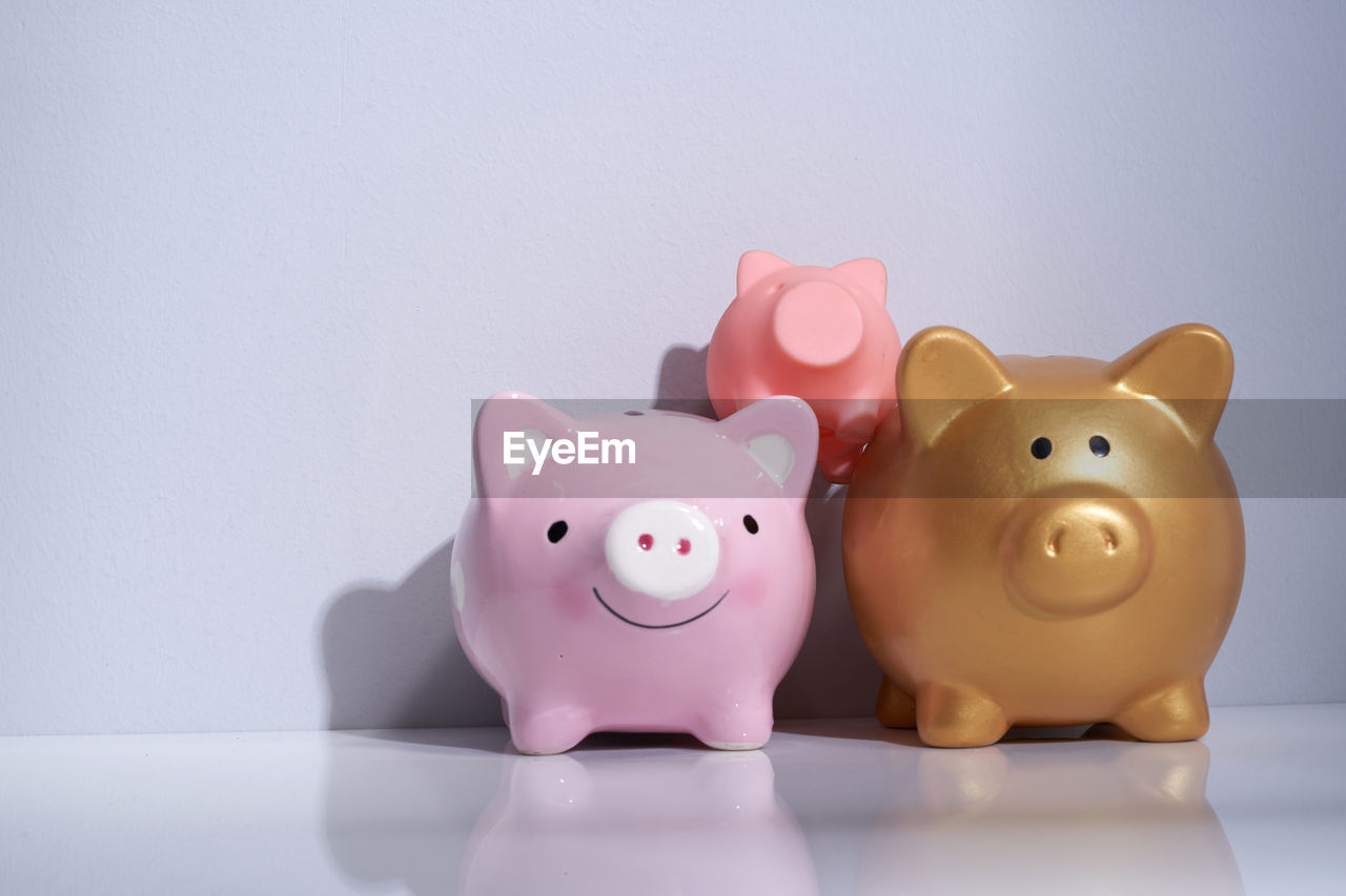 Saving money as a family piggy banks on white background