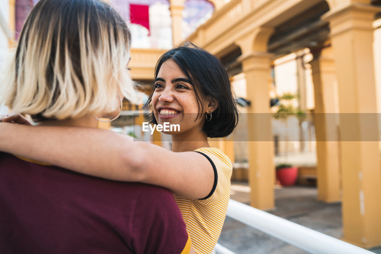 Close-up of lesbian couple romancing while standing in city