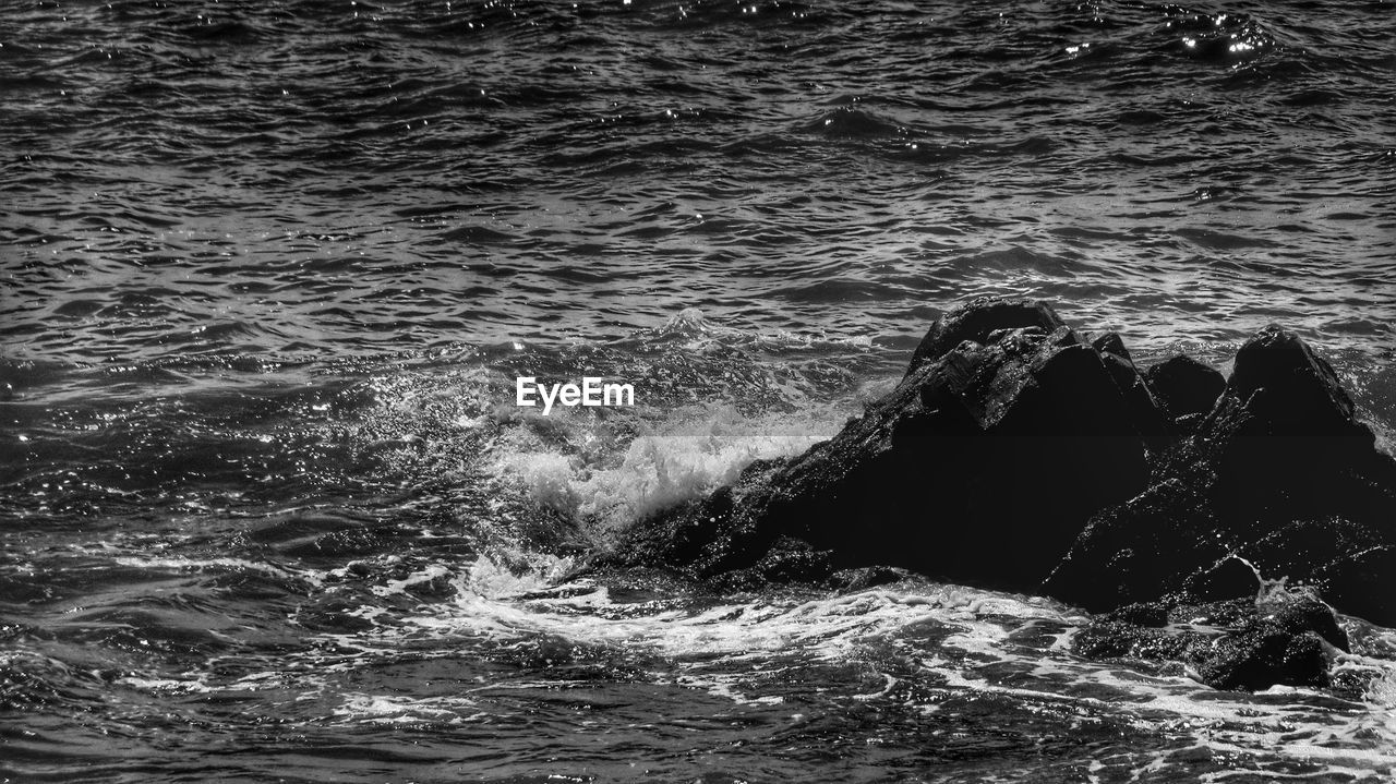 Close-up of rocks in rippled water