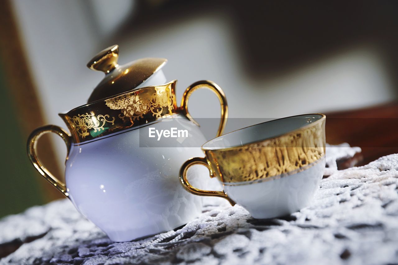 CLOSE-UP OF COFFEE CUP WITH SPOON AND FORK