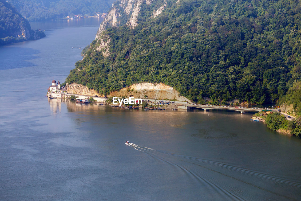 HIGH ANGLE VIEW OF RIVER BY TREES AND MOUNTAINS