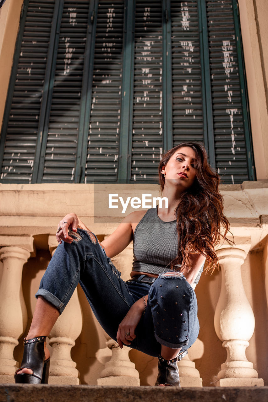 Beautiful woman posing on street photoshoot. young beautiful woman wearing casual clothing. 