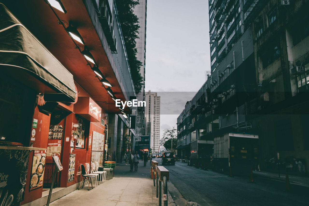 Street amidst buildings in city against sky