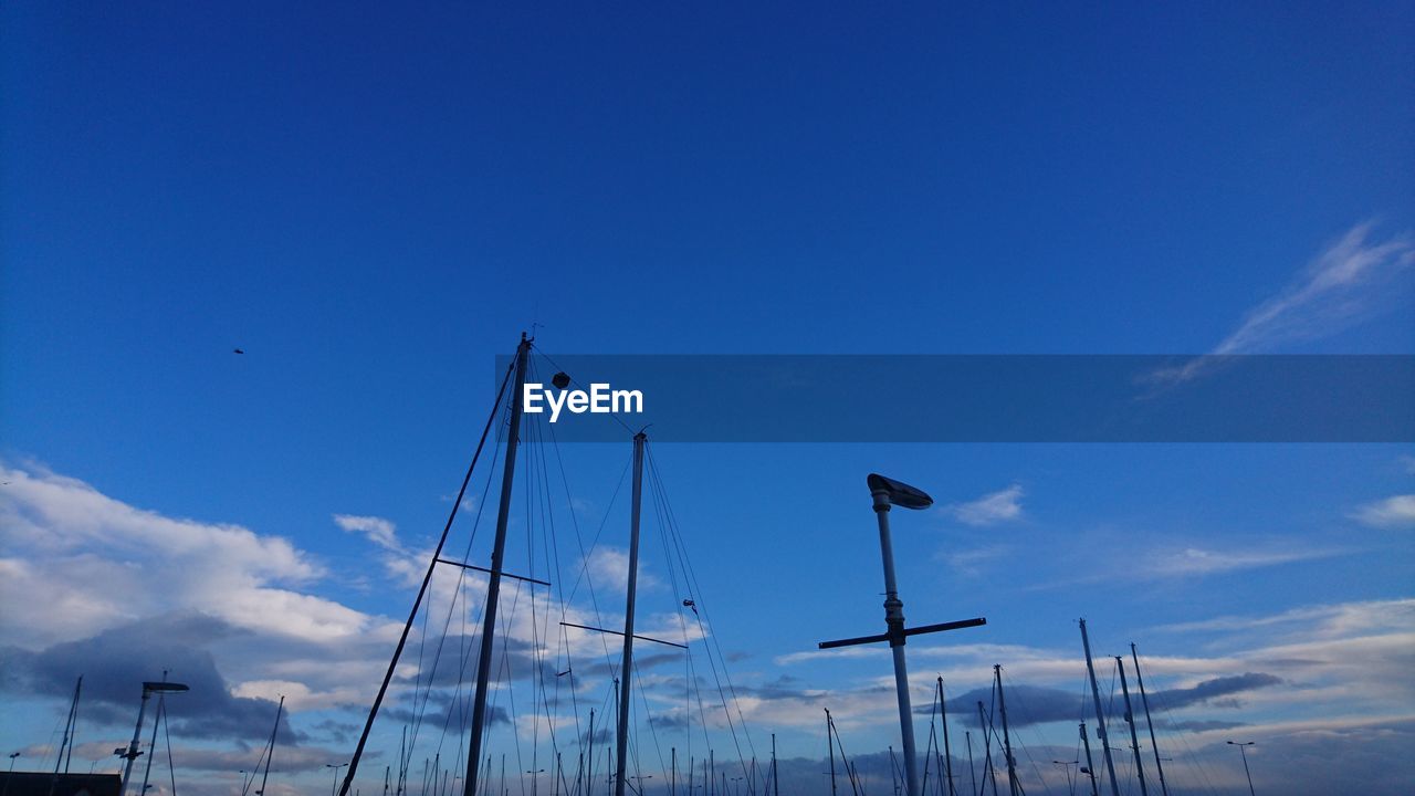 Masts against blue sky