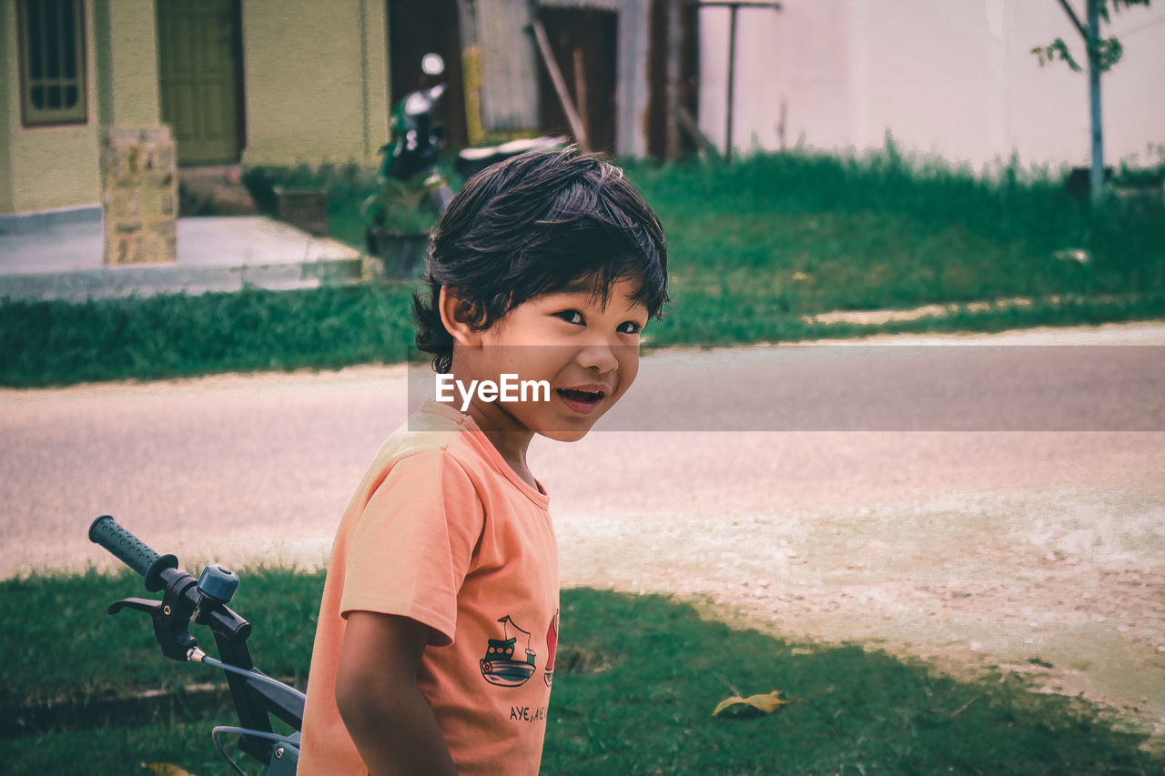 Portrait of cute boy standing outdoors